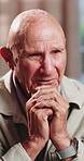 Therapy, thinking and senior man in office for counseling session, guidance or support for mental health. Reflection, sad and elderly person with conversation for memory, grief or nostalgia in clinic