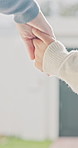 Mom, walking and holding hands with kid for outdoor safety, protection or security in neighborhood. Mother, trust or support with child, comfort or care for weekend, holiday or bonding together