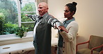Senior, man and stretching in clinic with physiotherapist, wellness and support for injury recovery. Elderly person, arm exercise and healthcare worker help with healing, rehabilitation or assistance