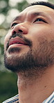 Thinking, calm and Asian man in park with inspiration, mindfulness and fresh air on summer break. Low angle, bokeh and male person with breathing, reflection and peaceful perspective on outdoor trip.