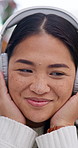 Happy, woman and relax in home with headphones, podcast and listen to favorite music on weekend break. Person, smile and satisfaction in house with audio tech, streaming radio and song for good mood.
