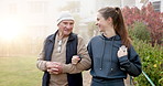 Walking, outdoor and woman with grandfather for wellness, mobility and fresh air at retirement center. Happy, morning and person with senior grandpa for talking, bonding and exercise for health