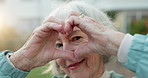 Elderly, face and happy woman with heart hands in garden for retirement, love or outdoor romance. Portrait, senior or female person with smile, like emoji or romantic gesture for passion or care
