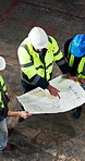 Above, engineer and team in building with blueprint, collaboration and advice for industrial project. People, talk and design document for engineering, manager opinion and planning for renovation.