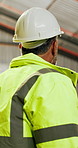Construction, hardhat or mature man with inspection, risk control or safety in building project. Assessment, back or engineer with helmet, ppe compliance or hazard prevention in industrial evaluation