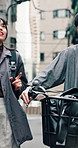 Couple, chat and walking with bike in city for morning commute, urban journey and bonding. Japanese people, happy and together with bicycle on sidewalk in town for travel, conversation and support