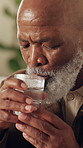 Senior, man and drinking water with trembling hands in home for parkinson, dehydration or stroke. Pensioner, black person and beverage with tremor for low blood sugar, neurological disease or thirst