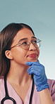 Nurse, thinking and woman with doubt in studio, remember choice and planning for healthcare service. Blue background, medical professional and person with health decision, contemplating or reflection