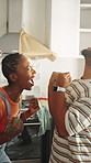 Celebrate, hug and couple in home for remodeling, renovation success and excited for progress. Happy, marriage and African man and woman high five, embrace or bonding with good news for house upgrade