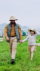 Farmer, dad and walking with child on poultry farm for agriculture or livestock together in nature. Father, kid or holding hands with daughter or chickens for food production or trip in countryside