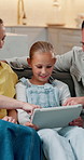 Smile, parents and child at house with tablet, social media and browsing website for movies. Happy, people and daughter in living room with digital, streaming film and comedy video for weekend break