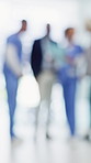 People, doctor and team with blur background for medical meeting or clinic discussion in hospital. Group, healthcare workers or nurses talking with colleagues for diagnosis, feedback or health advice