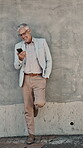 Laugh, break and man on wall with phone, online communication or comic post on social media. Happy, digital or mature person in town with tech, funny message or chat app notification on employee rest