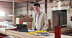 Face, carpenter and happy in workshop for manufacturing, trade and laptop for blueprint plans. Male person, smile and carpentry with tools for production, lumber factory and pride in profession
