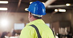 Carpenter, thinking and man with helmet in building, decision and planning for furniture production. Artisan, back and mature person with hard hat, flare and project inspection in factory and vision