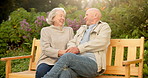Laugh, love and senior couple on park bench, happiness and holding hands for loyalty together. Retirement, man and funny woman outdoor for care, support and joke with partner in healthy relationship