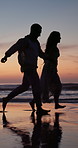 Sunset, couple and running at beach with travel adventure, holding hands and love for summer holiday. Evening, silhouette and people outdoor in ocean with relationship, romantic getaway and vacation.