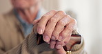 Senior, man and hands with cane in retirement home for mobility, assistance or movement aid. Elderly, male person or thinking with walking stick for nostalgia, support or assisted living in house