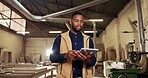 Black man, carpenter and walk in workshop with tablet, research and inspection for wood production. Thinking, person and supervision in factory with tech, quality control and manufacturing furniture