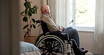Thinking, sad or old man at window with wheelchair, remembering or reflection of past mistake. Mental health, grief or elderly person in home with disability, emotional thought or guilt in retirement
