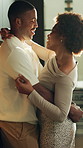 Dancing, happy and couple in kitchen with embrace for bonding, connection and romantic moment. Marriage, talking and African man and woman with music, movement and affection for relationship in home