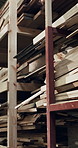 Shelf, wood and planks in workshop for carpentry, inventory and timber supply for production. Empty, factory and lumber in storage for renovation, joinery and woodworking for manufacturing furniture