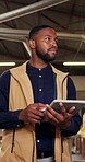 Tablet, ideas and carpenter in warehouse for planning furniture manufacturing with thinking. Digital technology, black man and woodworker with decision on production schedule on website in factory.