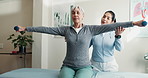 Physiotherapist, advice and old woman in clinic with dumbbells, strength exercise or rehabilitation. Senior person, healthcare worker and support with workout, weights and fitness for joint mobility.