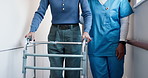 Nurse, help and elderly woman with walker in hallway for mobility, balance and support in retirement. Patient, caregiver and old person with disability, frame or rehabilitation for healing in house