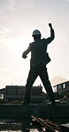 Engineer, fist pump and flare on construction site for building success, architecture and back. Architect, male person and happy for civil engineering, winning and weatherproof with water on rooftop