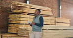 Carpenter, inspection and black man on tablet for inventory, quality assurance and checklist. Workshop, carpentry and person on tech for woodworking, timber production and evaluation report for wood
