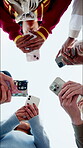 Group, texting and friends with phone, outdoor and searching for academic update on social media app. Low angle, students and people with mobile, internet connection and networking with technology