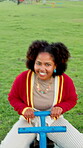 Face, fun and laughing with black woman on seesaw in park for holiday, vacation or weekend. Happy, portrait and pov with person at outdoor playground in nature for energy, excitement or wellness