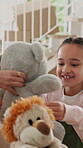 Happy mom, hug and child with teddy bear in home, connection and present for daughter in living room. Family, bonding and woman with gift, support and embrace with kid on weekend and love in house