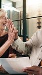 Couple, documents and high five with finance in home for winning, promotion or investment together. Interracial relationship, man and woman with smile or paperwork for financial success or profit