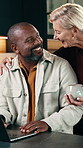 Couple, talk and remote work in house with laptop, bonding and support for husband in marketing job. Happy, interracial marriage and mature people with computer, advice or freelancer for advertising.