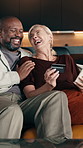 Payment, laughing or happy couple with credit card in home for online shopping, purchase or banking. Interracial relationship, man and woman with smile, debit or humor for ecommerce or app in house