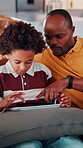 Tablet, child and dad with game on sofa for online puzzle, problem solving or bonding activity. Black people, man or boy with tech in home for playing family trivia, learning support or weekend break