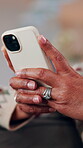Scroll, phone and hands of old woman on sofa in home for bingo app, social media or chat. Text message, gaming subscription and virtual dealer with senior person in living room for connection 