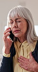 Phone call, chest pain and elderly woman in home for healthcare, consultation or explain symptoms. Pensioner, discomfort and tech in living room for doctor appointment, feedback or medical assistance