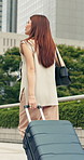 Woman, travel or walking with suitcase in town for commute, job opportunity or tourism. Thinking, female person or traveler with luggage or phone in an urban city for journey or road trip on sidewalk