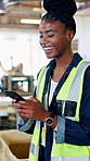 Happy, woman and woodworker in workshop with phone, typing text message and laugh for social media meme. Black person, smile and break in carpentry factory with mobile tech, internet and funny joke.