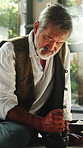 Old man, grinding and bowl with herbs for ritual, scripture and herbal medicine for holistic healing. Senior shaman, mixing and recipe at house with plants, aromatherapy paste and indigenous remedy
