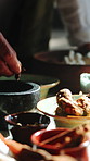 Hands, healer and bowl with herbs for ritual, scripture and herbal medicine for holistic healing. Person, shaman and ingredients in home with plants, aromatherapy and indigenous remedy for traditional