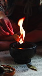 Fire, herbs and hand with natural ritual for mindfulness, healing and culture with flame. Zen, incense and person in ceremony with alternative medicine with spiritual energy, aromatherapy or cleanse