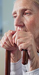 Old woman, thinking and sad with walking stick, lonely and disappointed with memory loss or dementia. Nursing home, reflection and senior person with disability, Alzheimer and contemplating with cane