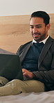 Happy, laptop and business man in hotel for internet, check emails and travel agenda for hospitality. Night, bed and person typing on computer for planning, online itinerary and website for work trip