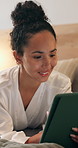 Happy, night and woman on tablet in hotel for online itinerary, digital streaming and subscription. Relax, hospitality and person on tech for internet, research or travel schedule for holiday on bed