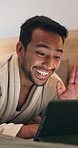 Wave, bed and man with tablet for video call, checkin discussion or hello in hotel room. Happy, male person and travel with smile, talk and technology for communication or virtual chat in resort