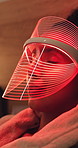 Mask, sleep and woman with red light therapy on bed for skincare, beauty or facial wellness. Health, afternoon nap and person with face LED treatment for collagen production in bedroom at apartment.